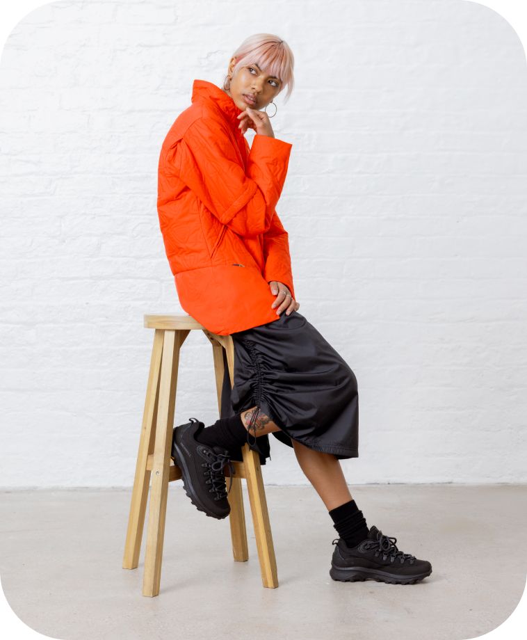 Model sitting on stool with black ontario speed lace shoes on 