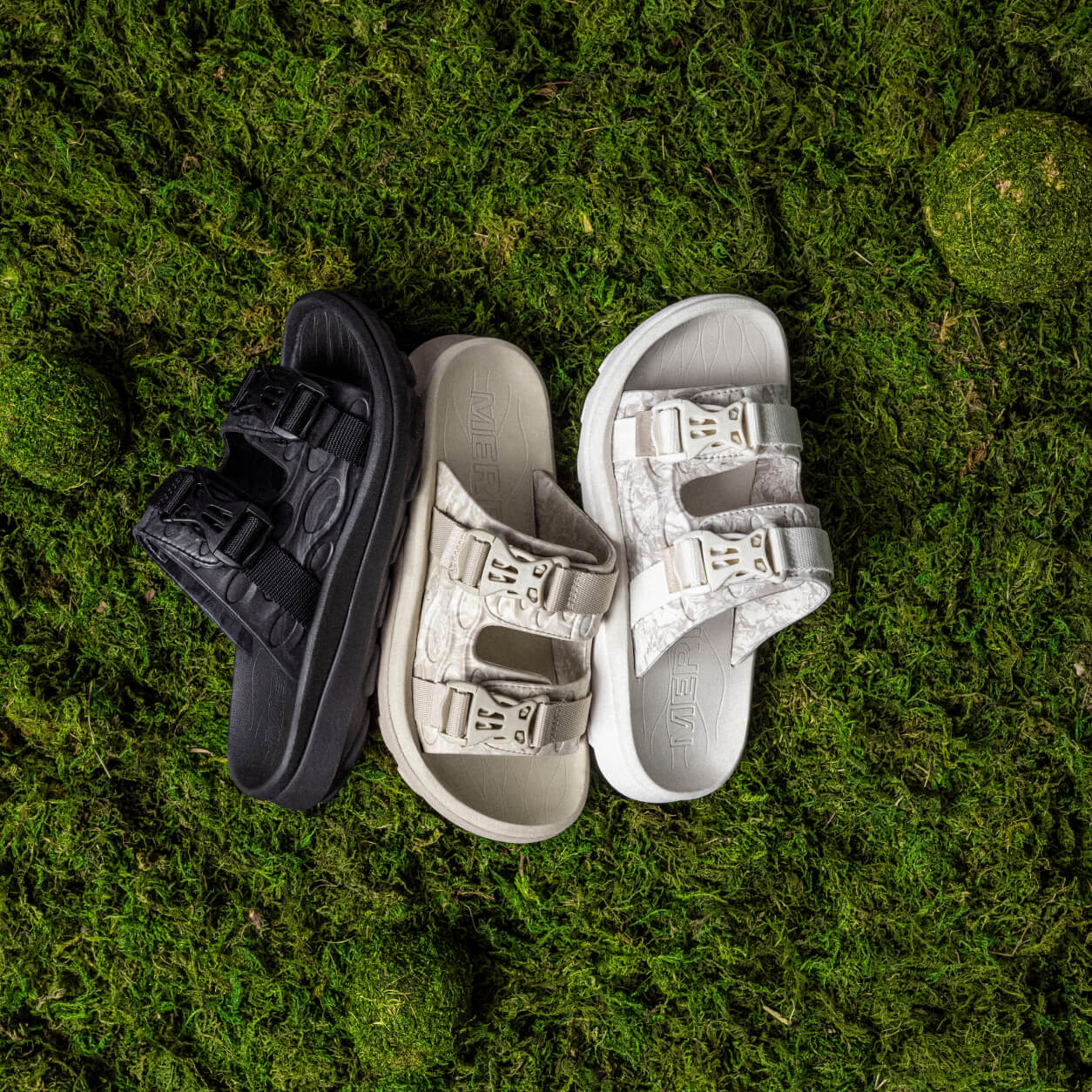 Sandals laying on a soft bed of moss.